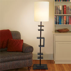 lamp made from a curtain rod standing lit in a room