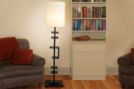 lamp made from a curtain rod standing lit in a room