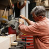 Tom Silva cuts the leg for a trestle table with a miter saw