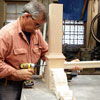 Tom Silva attaches the stretcher for a trestle table to the table leg