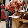 Tom Silva attaches a leg plate to the table leg for a trestle table with a drill/driver
