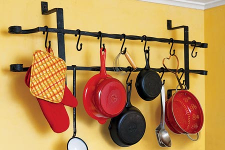 a pot rack that is made from a vintage window guard