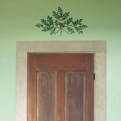 an oak-branch motif stencil above a door