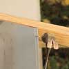 Mark Powers starting to nail the siding onto his trash shed