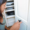 inserting the knob post after predrilling a hole centered on the shutter