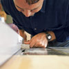 man roughing out profile of custom molding