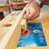 man using router to shape custom molding