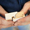 man using sanding block to smooth out rough molding