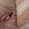 inserting the glued dowels into the pilot holes