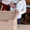 attaching the base to the bottom of the storage chest