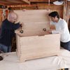 attaching the hinges to the lid of the storage chest