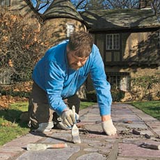smoothing fresh mortar joints with a brush
