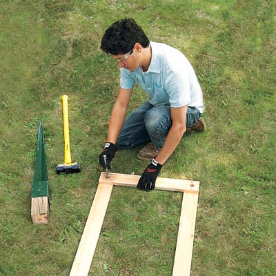screwing together a template to make pilot holes in the post anchors