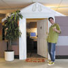 Mark Powers holds up a margarita outside a made over office cubicle