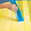 removing the last row of tape for the finished herringbone pattern on a tabletop
