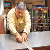 Tom Silva trims the acrylic top with a straightedge and utility knife