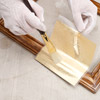 Applying metal leaf to wood frame