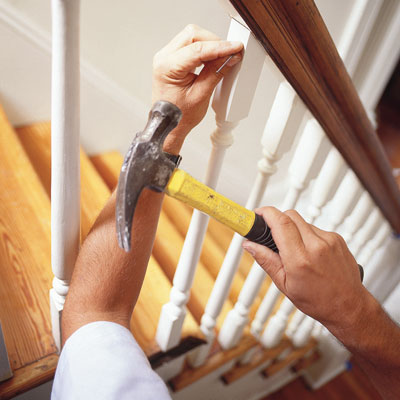 nailing a baluster into place