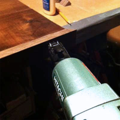 Glue the edge trim to the tabletop to Build a Hairpin-Leg Coffee Table