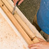 clearing the lamppost's wiring channel with a wood chisel