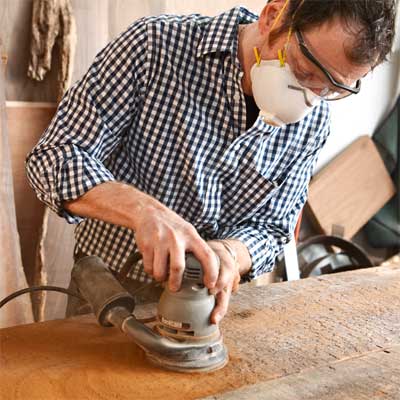 sand the top to build a table from salvage beams