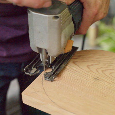 cutting away the rounded part of the armrests of a Westport chair with a jigsaw