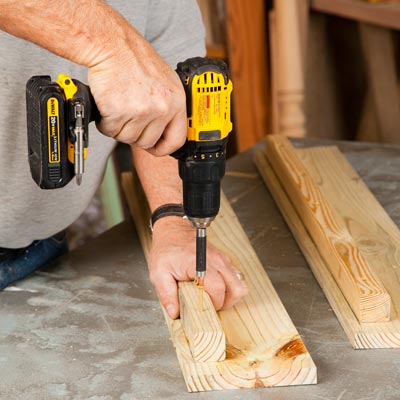 Tom Silva attaching a cleat to a side board with a drill/driver