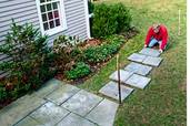 a stepping stone path made of stone pavers