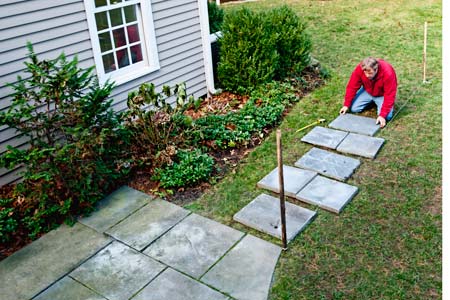 a stepping stone path made of stone pavers