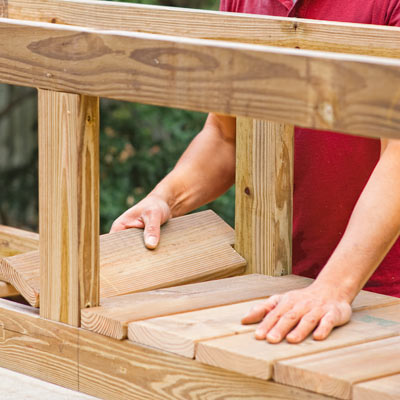 Mark Powers places the rest of the floorboards of the planter
