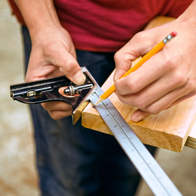 Mark Powers marks the corners of the top trim of the trellis to be beveled