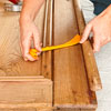 removing an astragal from a cabinet door with a cat's paw