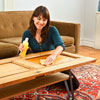 applying the top coat to a newly finished coffee table