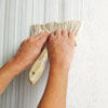 applying the faux fabric finish with a stiff-bristled brush