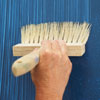 applying blue glaze faux fabric with a stiff-bristled brush
