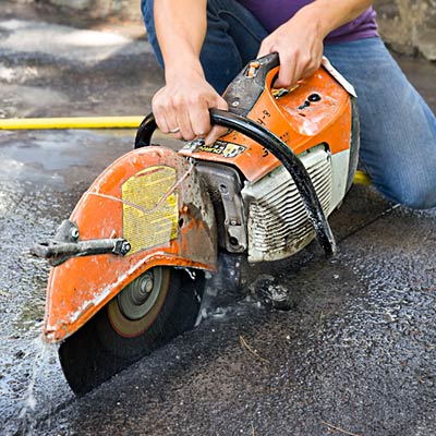 cutting a driveway with a concrete saw