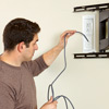 inserting cables for hanging a flat-screen tv 
