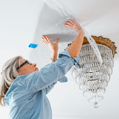 adhering the stencil to the ceiling