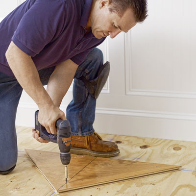 fixing a triangular nailing blank to the subfloor for a herringbone floor install