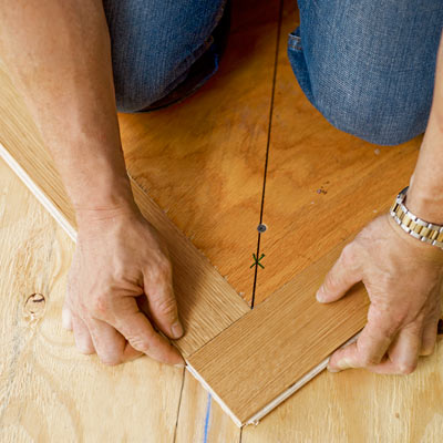 fitting two wood slats together perpendicularly for a herringbone floor