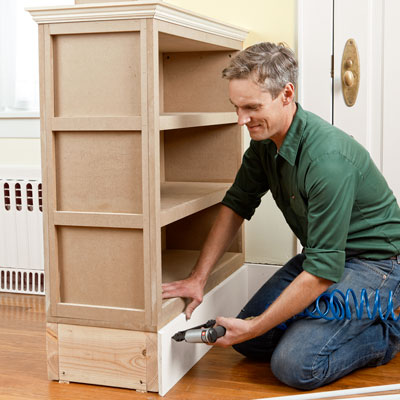 attaching baseboard molding to the columned room divider