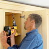 attaching the hardwood frame with crown molding to the kitchen cabinets