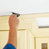 scribing the gap between a kitchen cabinet with crown molding and the ceiling
