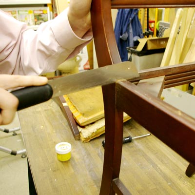 cutting off a chair-front with a flush-cut pull saw