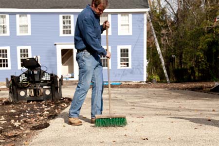 roger cook sweeping stone for a low-maintenance, all-gravel driveway