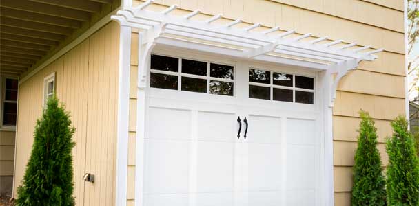 a newly installed pergola above a garage door