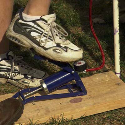 foot operated bicycle pump with pressure gauge attached