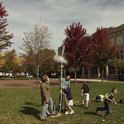 Kevin O'Connor, Slater Harrison and group of kids launch a rocket