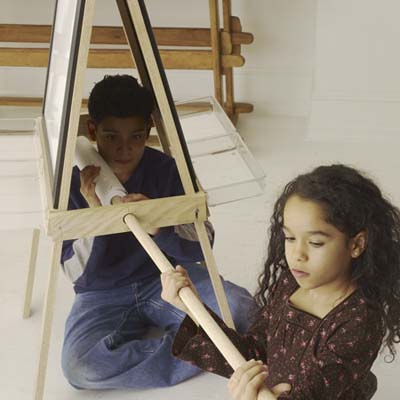 kids sliding paper roll to the easel