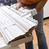use the construction adhesive to affix the decorative entablature to the 2x4 top